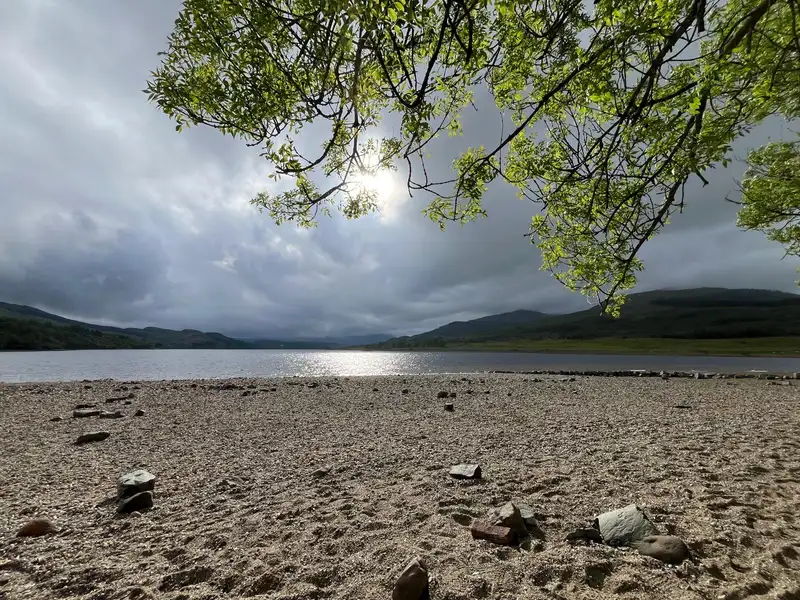Wild swimming in a sun-lit Scottish loch